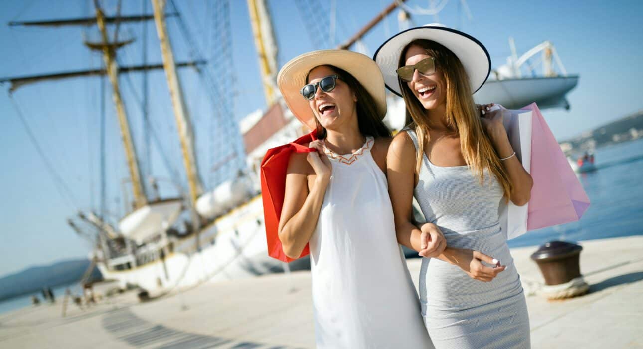 two women next to a yacht at La Baia North Bay Harbor Islands